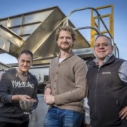 Russell Brown, Enzo Palombo and David Filipenko standing next to Viridi's processing equipment